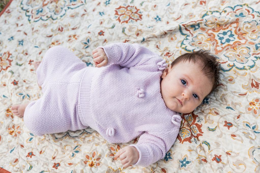 Celia, a two-month old baby, on a blanket