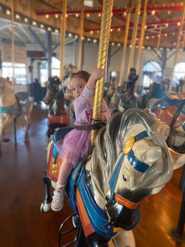 Alma riding a carousel